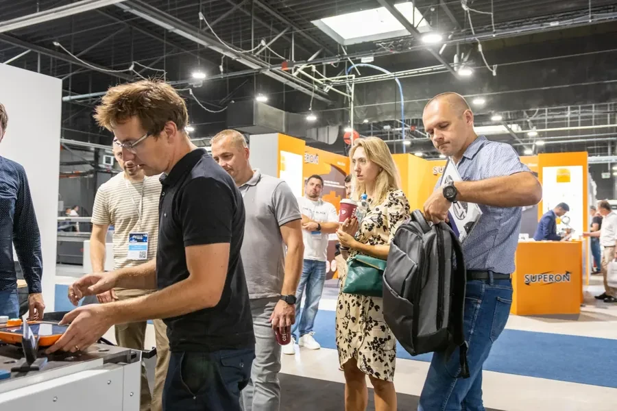 Visitors trying out equipment at an exhibitor stand, European Industry Week 2025
