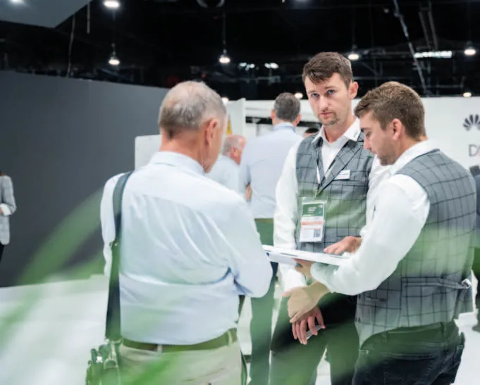 Exhibitors meeting visitors at a stand